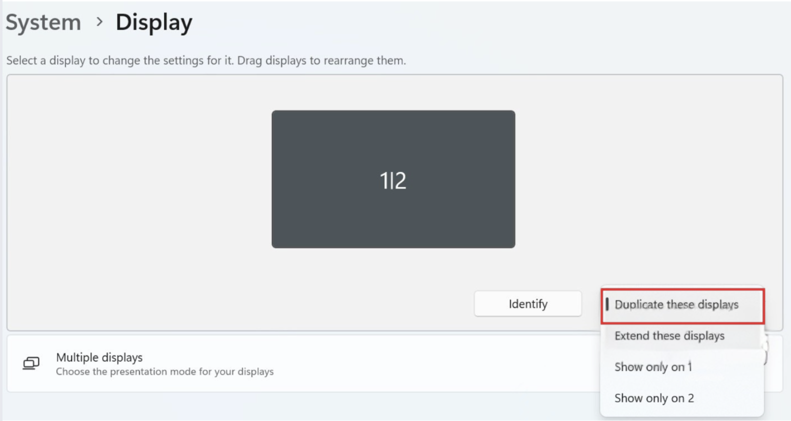 Windows 11 System Display settings with the Multiple displays drop-down open showing Duplicate these displays